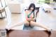 A woman sitting on top of a wooden table.